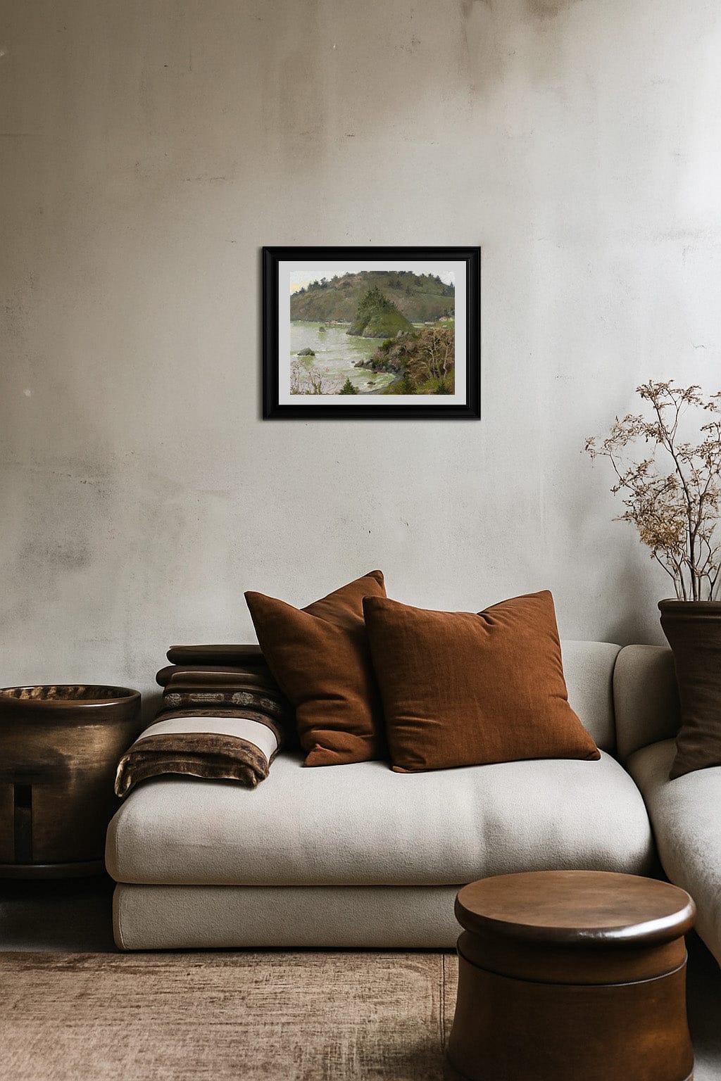 Cozy living room with a beige sofa, brown cushions, and a framed picture on the wall.