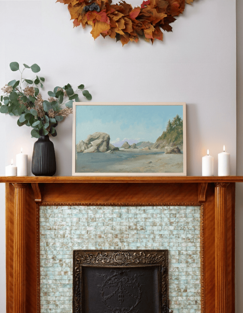 Wooden mantelpiece with a landscape painting of sea stacks by Leo Stafsnes, candles, and decorative leaves above.