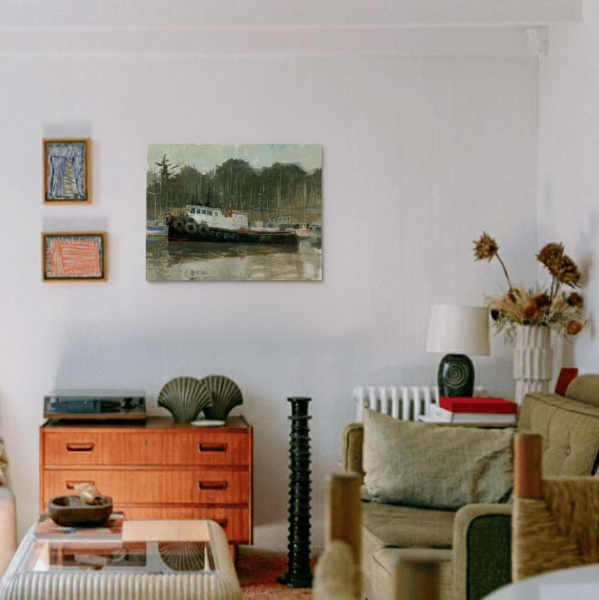 Living room with a wooden dresser, armchair, and artwork on the wall.